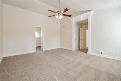 Carpeted spare room featuring a textured ceiling, 