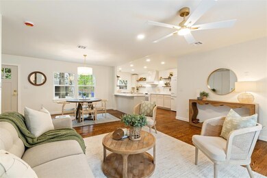 Living room with baseboards, visible vents, wood f