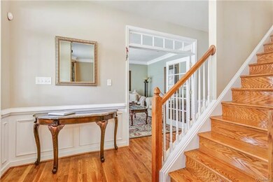 Foyer with hardwood floors and hardwood on stairs 