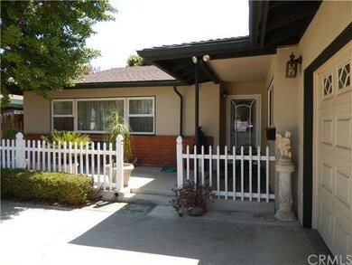 Charming white picket fenced front porch