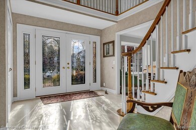 Entrance foyer featuring french doors and stairs
