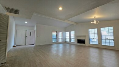 Unfurnished living room with a tiled fireplace, wo