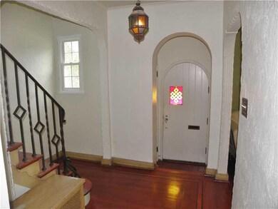 Entry/Foyer. Charming Entry w/ Arched Wood Door fe