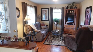 Nicely Sized Living Room has Hardwood Floors and a