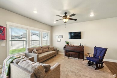 Living room with ceiling fan and recessed lighting
