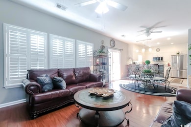 Living area featuring a ceiling fan and wood finished floors