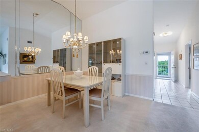 Carpeted dining room featuring high vaulted ceilin