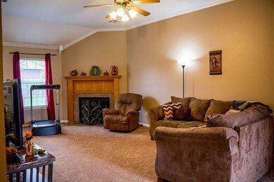 Spacious living room with beautiful crown molding and fireplace!