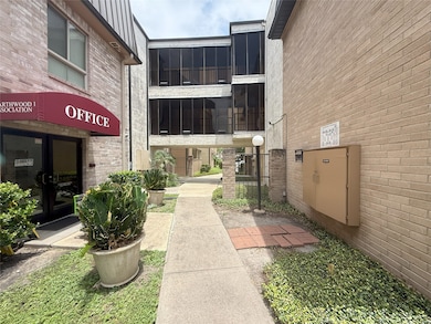 This photo shows a walkway between brick buildings
