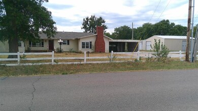 View of front of property with a garage and an out