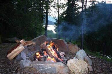 Day's end around the fire while river flows on by
