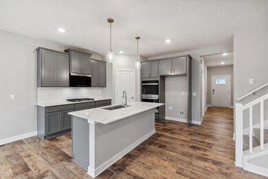 The home chef will enjoy the stainless appliances in our Signature Whirlpool kitchen: double wall oven, 4 burner gas cooktop, vented microwave, dishwasher and tiled backsplash.