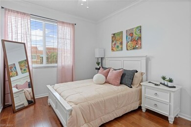 Bedroom featuring crown molding and wood finished floors