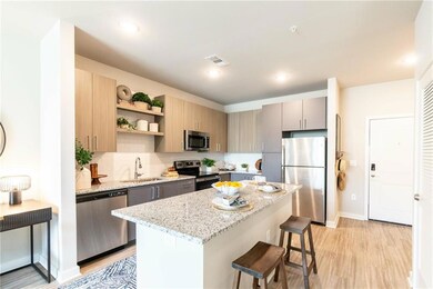 Kitchen with sink, a breakfast bar area, appliance