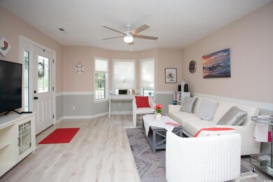 Living room featuring ceiling fan and light hardwo