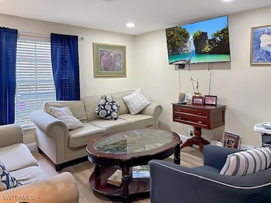 Living area featuring wood finished floors and recessed lighting
