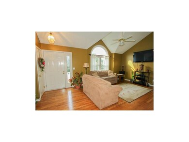 GREAT ROOM WITH CATHEDRAL CEILING AND FAN.
