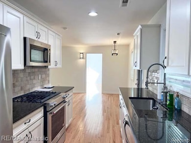 Kitchen towards living room and primary bedroom