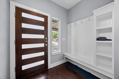 Mudroom featuring dark wood finished floors and b