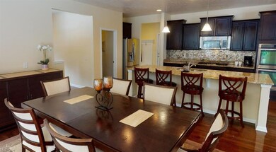 Dinette overlooking kitchen and leads to sunlit mo