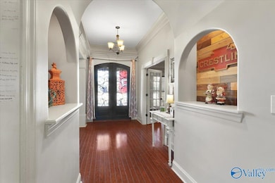 Lighted art and decor cubbies along the foyer hallway to the rest of the home.