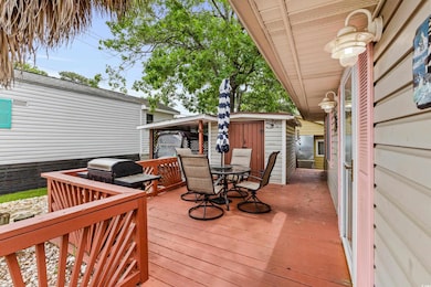 Deck with outdoor dining area and area for grilling