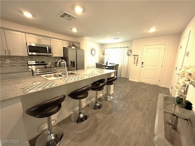 Kitchen featuring visible vents, dark wood finishe