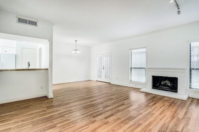 Open floor plan, wood burning fireplace, and Frenc