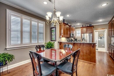 Dining space featuring crown molding, a chandelier