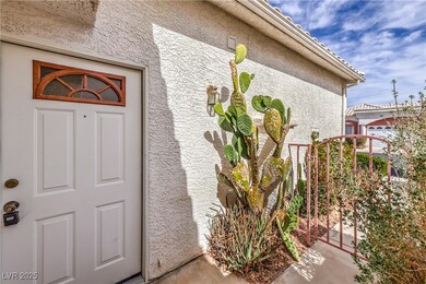 Entrance to property with a tile roof and stucco s