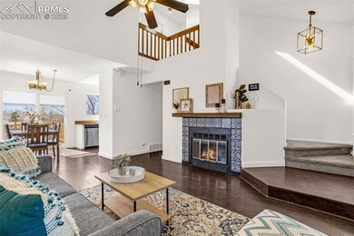 Living area with baseboards, visible vents, a tile
