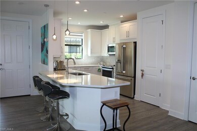 Kitchen featuring a breakfast bar area, appliances