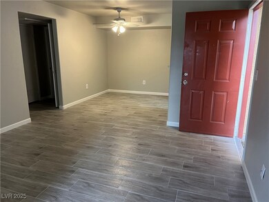 Foyer with baseboards, ceiling fan, and dark wood-