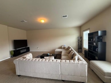 Carpeted living room featuring baseboards