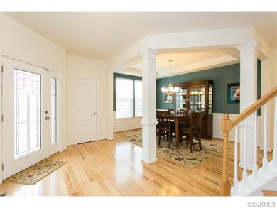 Foyer with hickory floors, open to dining room & w