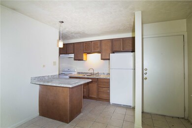 Kitchen with white appliances, under cabinet range