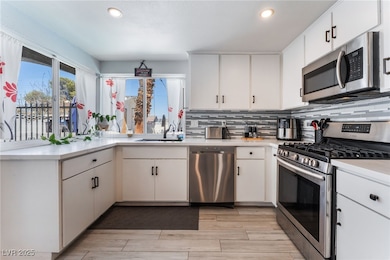 Kitchen with stainless steel appliances, light cou