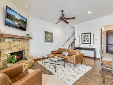 Living area featuring arched walkways, a fireplac