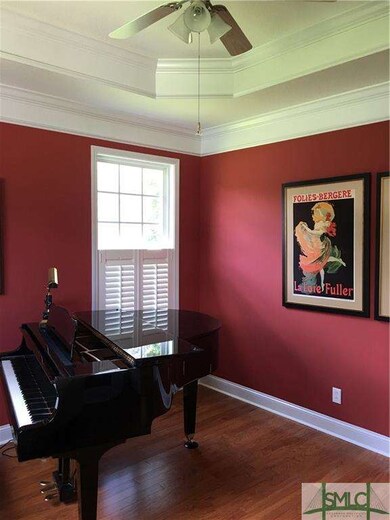 Living room with beautiful tray ceiling and crown 