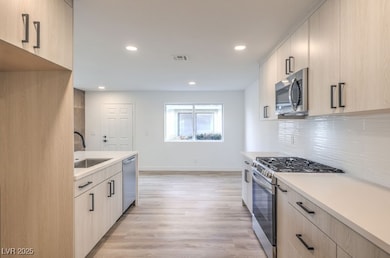 Kitchen with stainless steel appliances, light bro