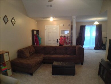 large family room with column  and view of dining 