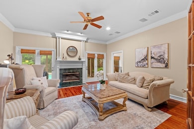 Living area featuring wood finished floors, a cei