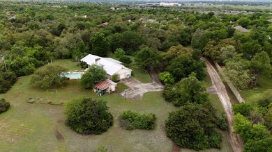 Birds eye view of property with a forest view