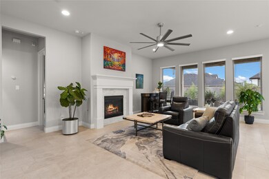 Gather the family and guests together in your lovely living room! Featuring high ceilings, recessed lighting, a modern ceiling fan, custom paint, gorgeous floors, fireplace with mantel and large windows that provide plenty of natural lighting throughout the day.