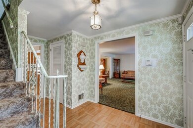 Welcoming Foyer Opens to the Living Room on the ri