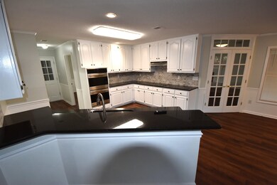 Kitchen featuring white cabinetry, sink, kitchen p