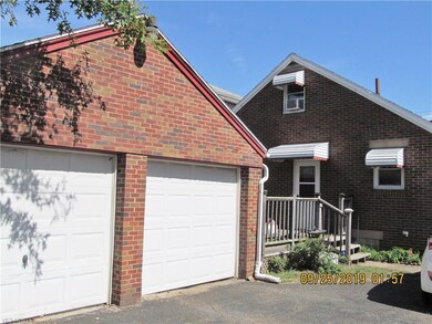 View of 2 car garage and back deck