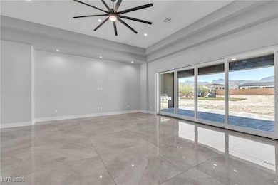 Living room with recessed lighting and a ceiling f