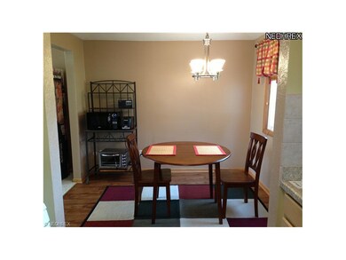 Spacious dining area with laminate floors.