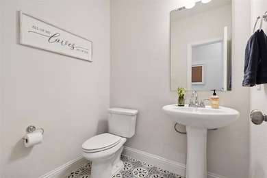 Bathroom with tile patterned flooring, toilet, a s